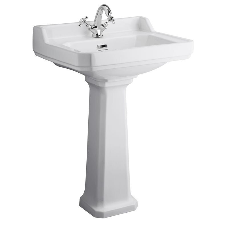 vitt tvättställ i porslin med ett blandarhål på förhöjd piedestal